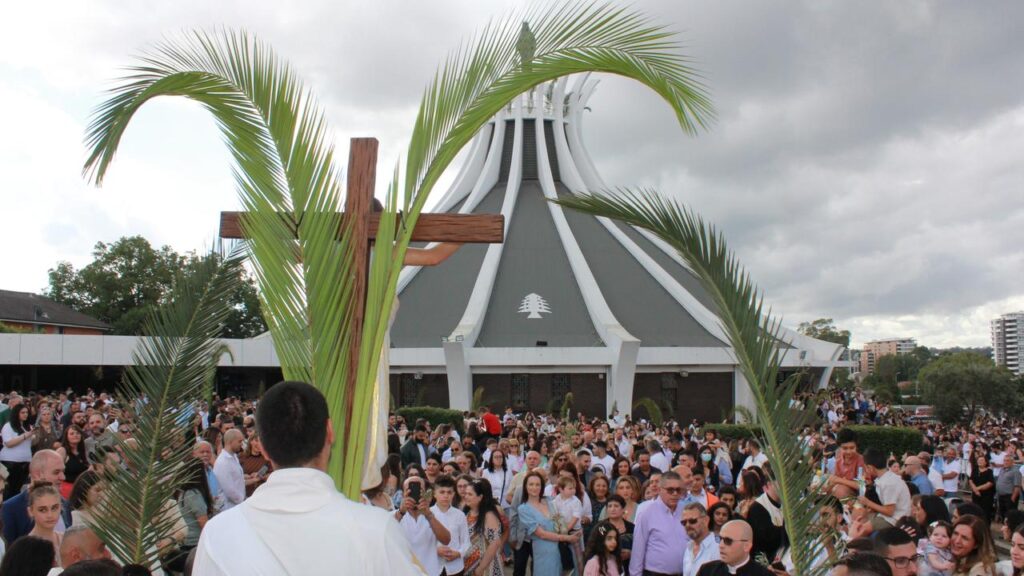 A diverse group of Maronite community members engaging in a worship service, symbolizing their commitment to faith, education, and social support.